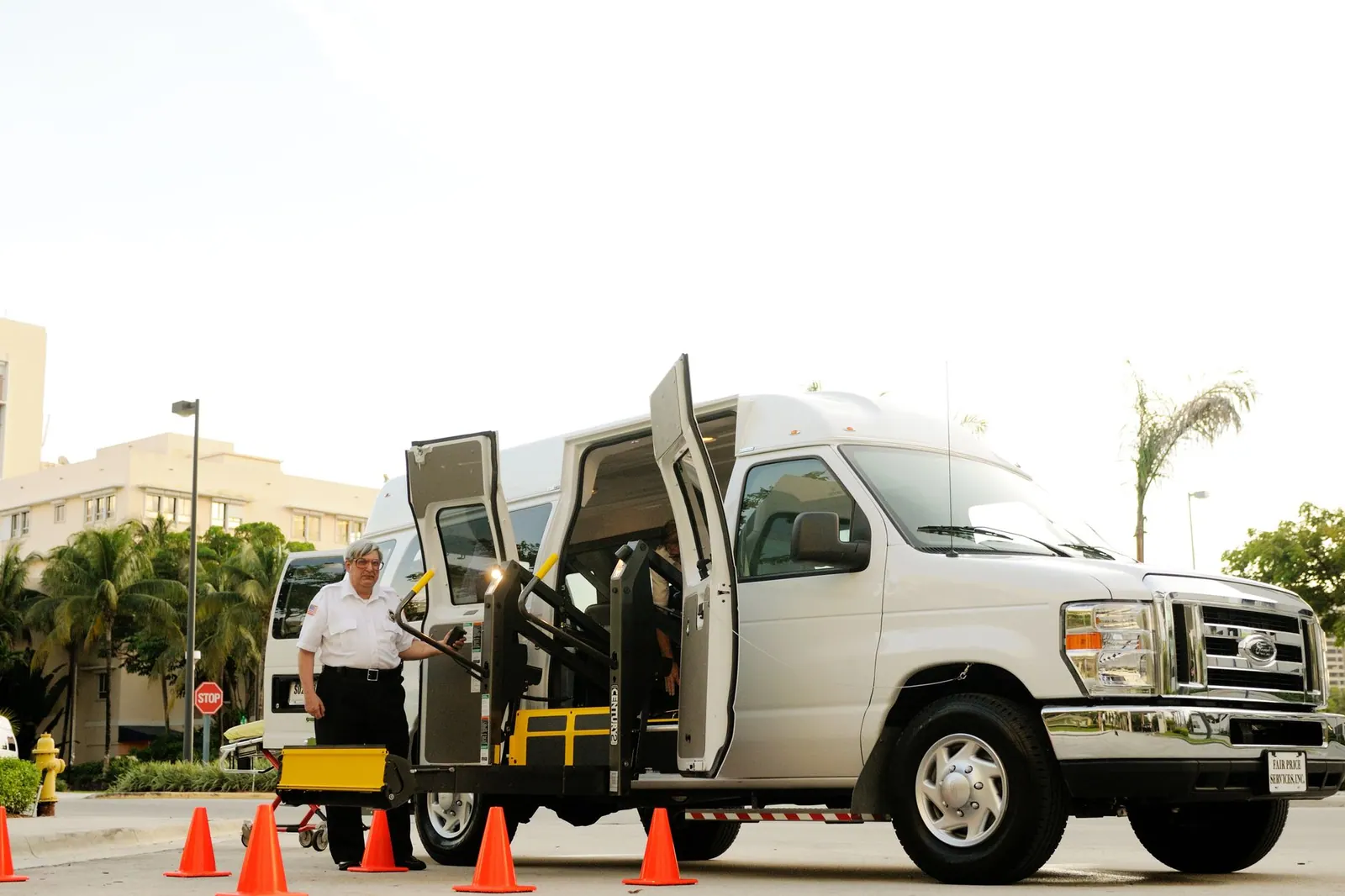 A driver standing by a wheelchair accessible van with open doors and a ramp, surrounded by cones. A two-day itinerary that survives the usual mistakes