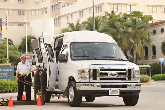 Accessible transportation van prepared for boarding with driver assistance in urban environment. Mobility-friendly hotels: how to compare them by location