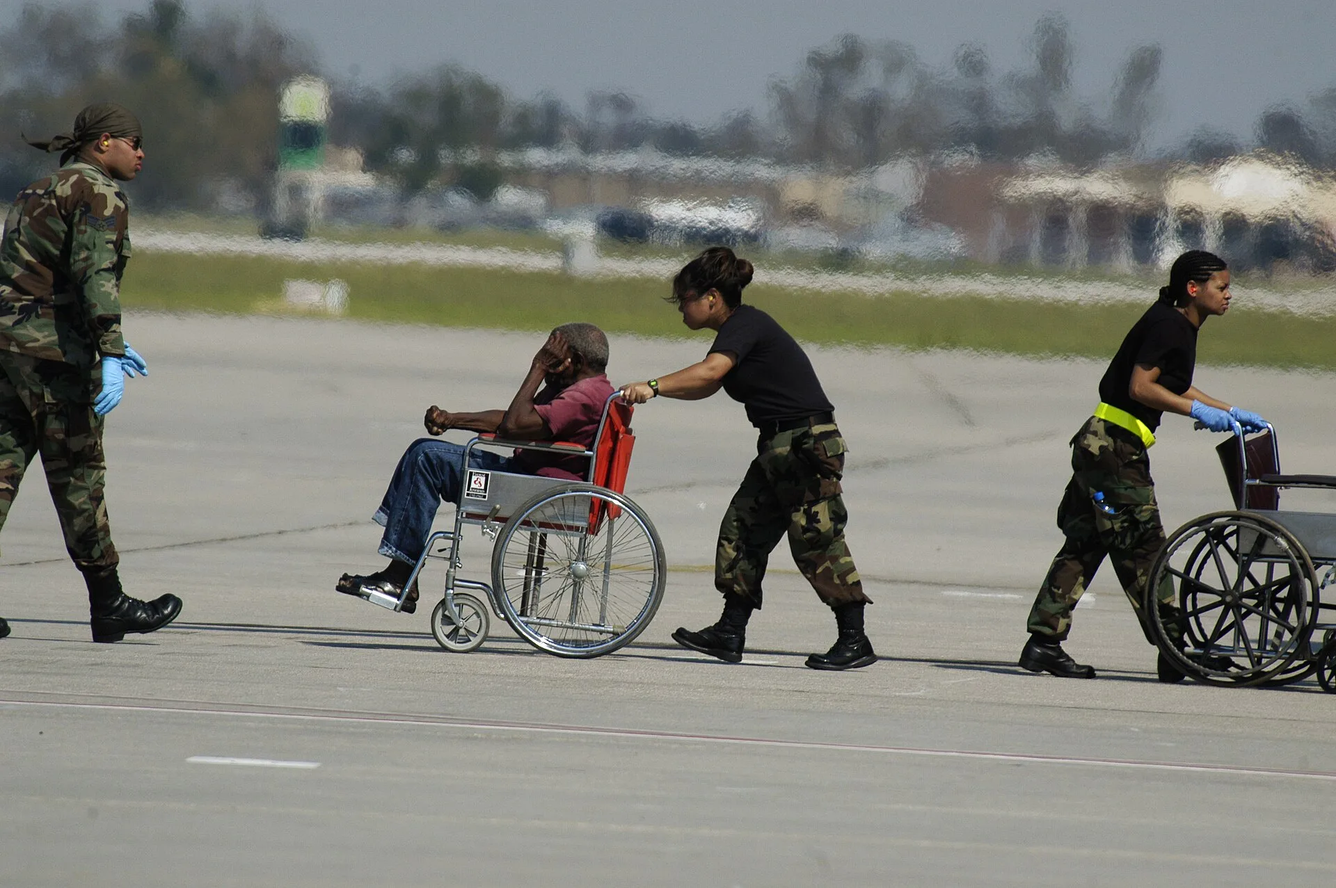 New Orleans, LA, 9/4/05 -- An evacuee being pushed in a wheel chair at the New Orleans Airport which is being used as a stageing area to send people to shelters around the country. New Orleans is being evacuated because of flooding caused by hurricane Katrina. Photo by: Liz Roll. How to Request Wheelchair Assistance at a U.S. Airport