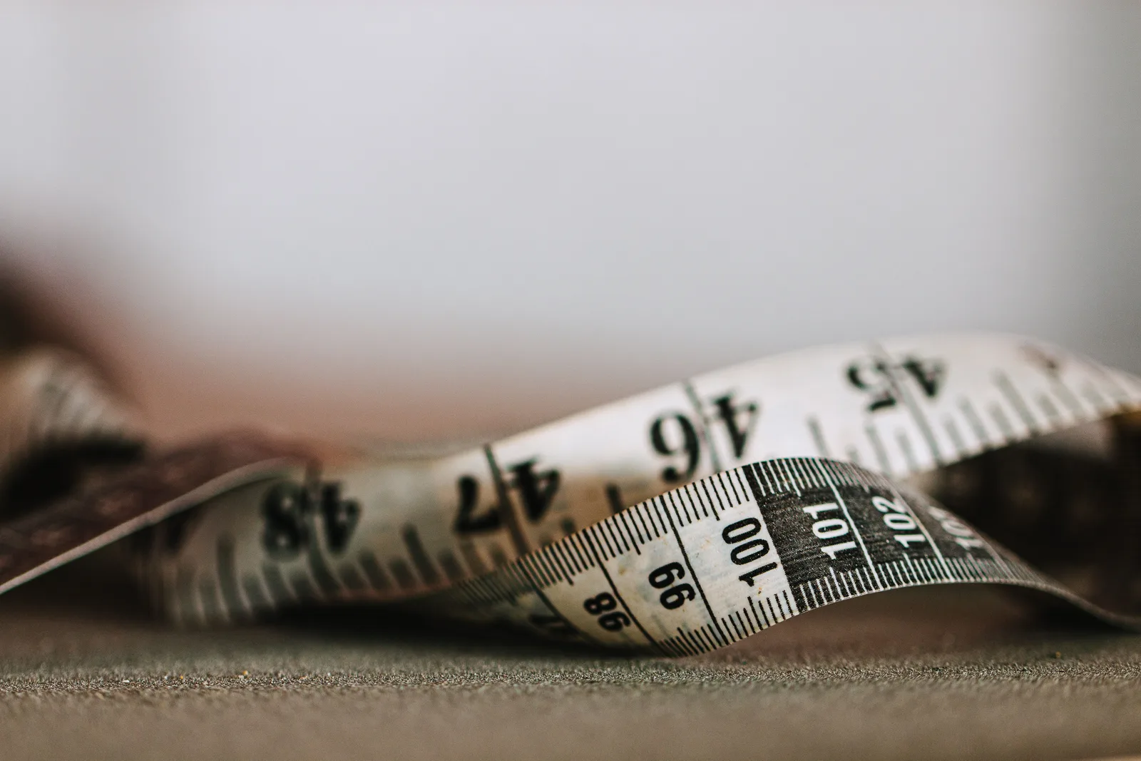 Artistic shallow focus image of a measuring tape showing numbers and units. What to know before a wheelchair accessible trip: chair measurements, transfers and repair plans