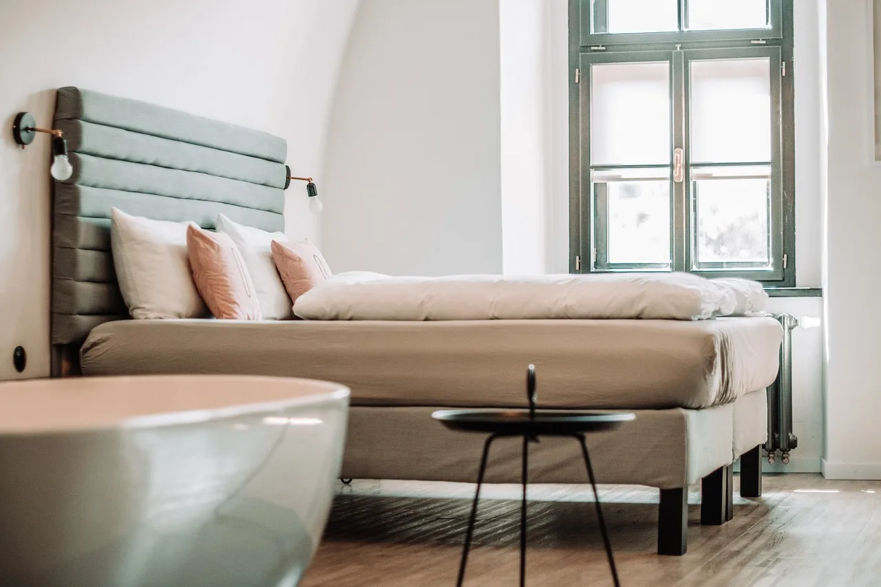 bedroom, indoors, interior design, hotel, furniture, room, bedroom, bedroom, bedroom, hotel, hotel, hotel, hotel, hotel. Lodging that fits a tight accessible travel budget